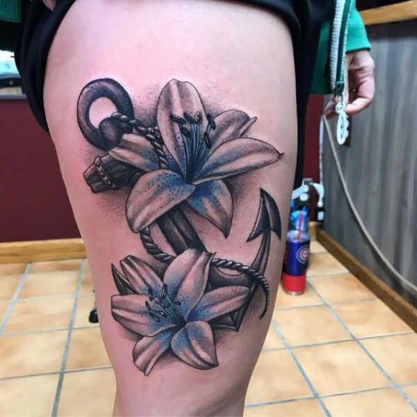 Lily and anchor tattoo in dark and realistic style