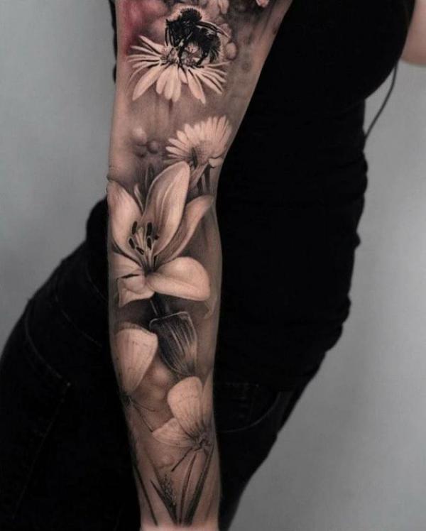 Realistic lily and aster sleeve tattoo black and grey