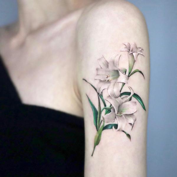 Realistic white easter lilies with green leaves