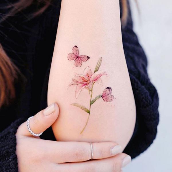 Small lily and butterfly tattoo