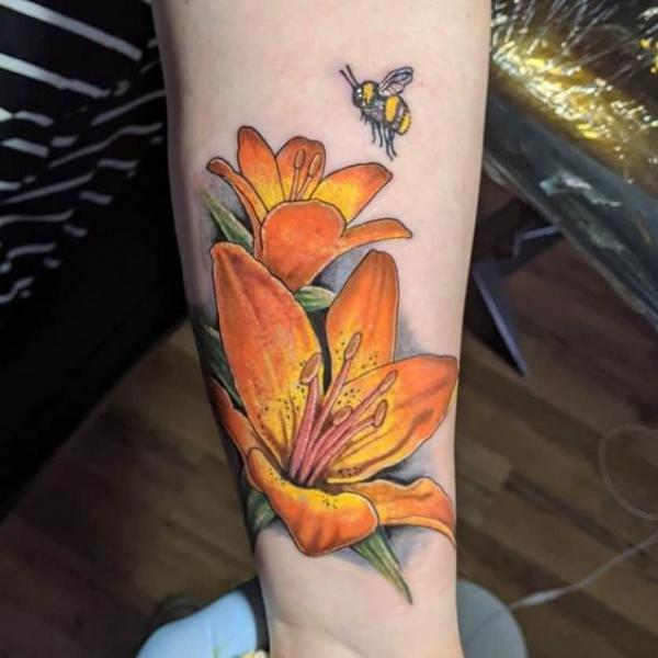 Yellow lily and bee tattoo