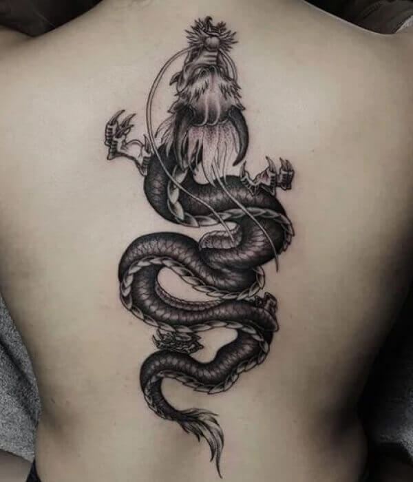Black and white dragon spine tattoo