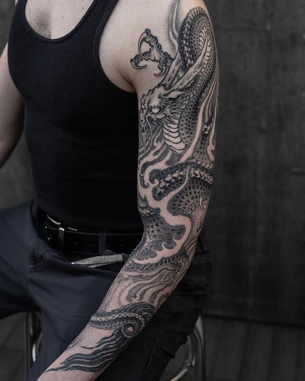 Dragon and cherry blossoms sleeve tattoo