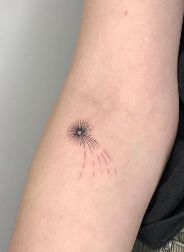 Minimalist shooting star tattoo