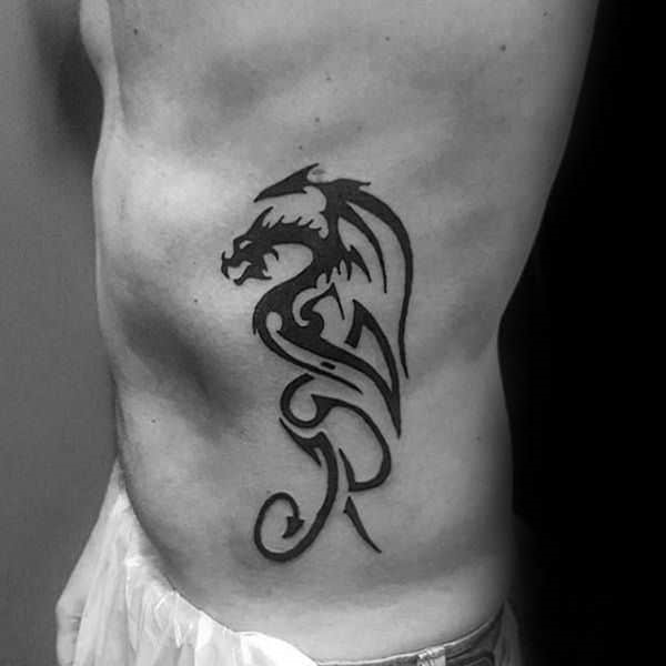 Small dragon tribal tattoo on rib