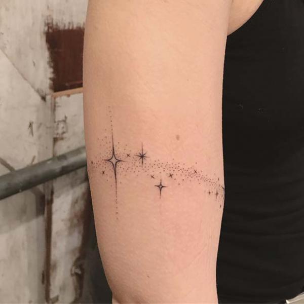 Sparkle star arm tattoo