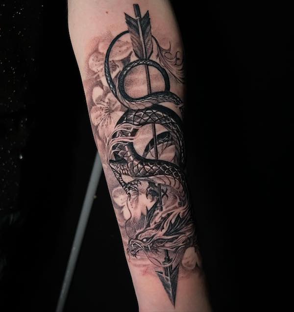 Sword and dragon forearm tattoo
