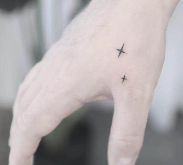 Tiny star hand tattoo