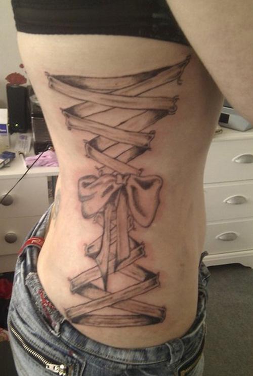 Corset piercing tattoo on side