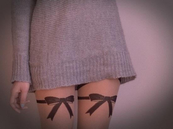  Garter ribbon tattoo on thigh