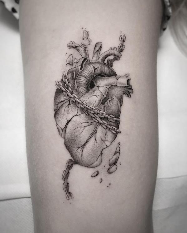 Black and grey human heart wrapped with chain