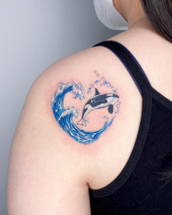 Blue wave and whale shoulder tattoo
