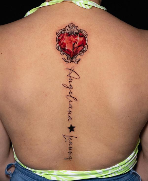 Diamond heart spine tattoo with cursive words