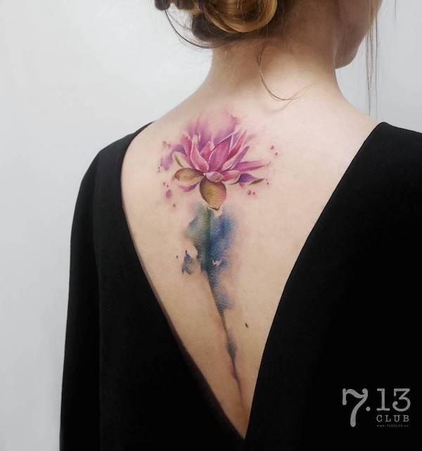 Watercolor lotus with stem spine tattoo
