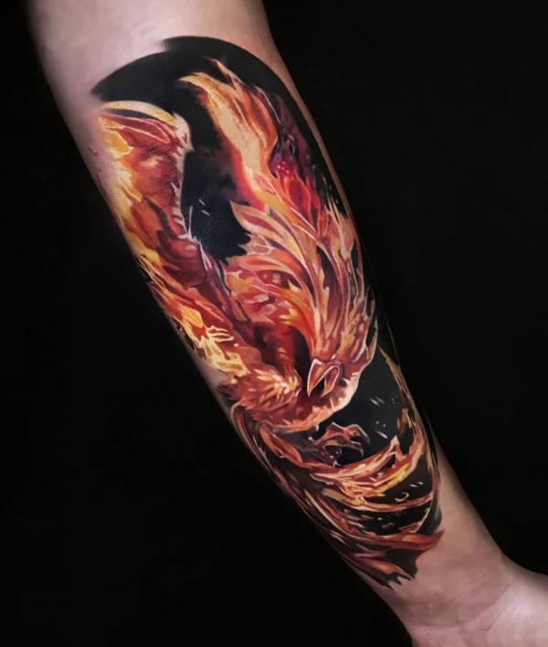 Firing phoenix forearm tattoo