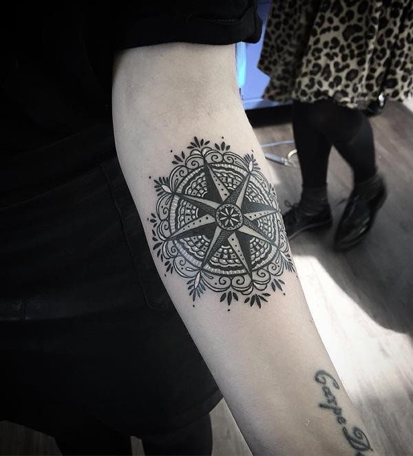 Wind rose on the background of Mandala pattern