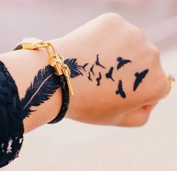 Silhouette Tattoo with Feather And Flying Bird on Hand And Wrist For Girl