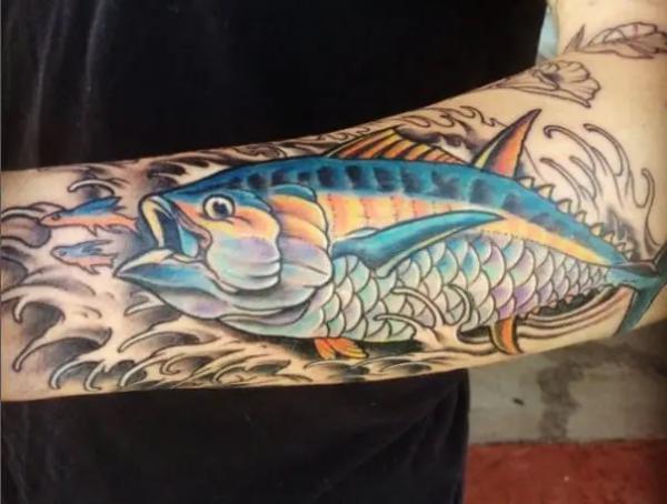 Tuna and wave forearm tattoo