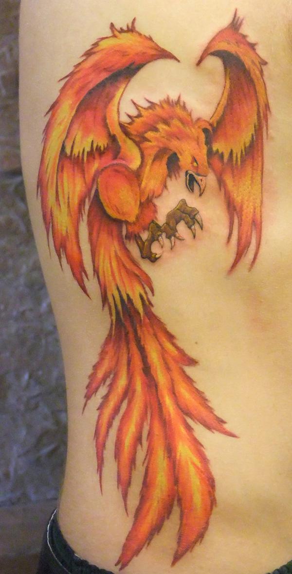 glowing phoenix rib tattoo