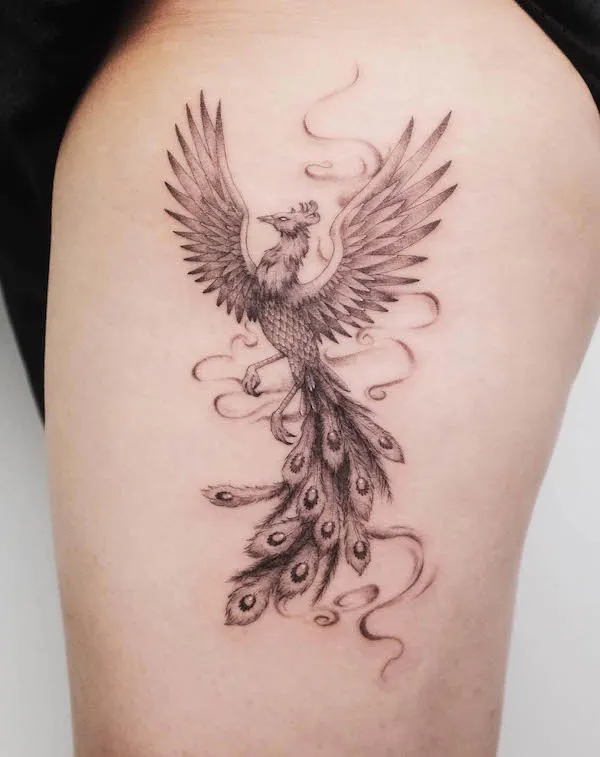 phoenix thigh tattoo with peacock feathers