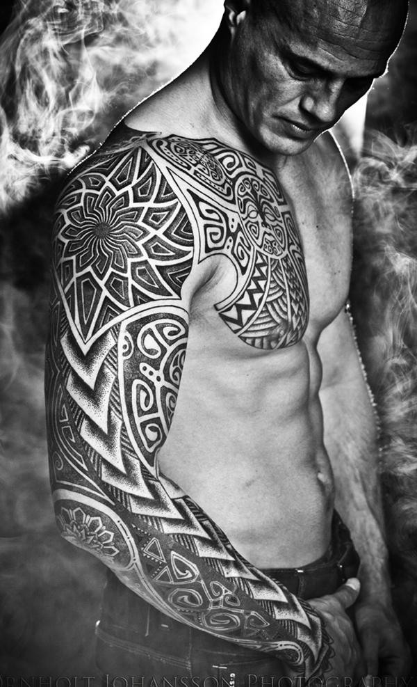 Single needle Spartan tattoo on the left shoulder.