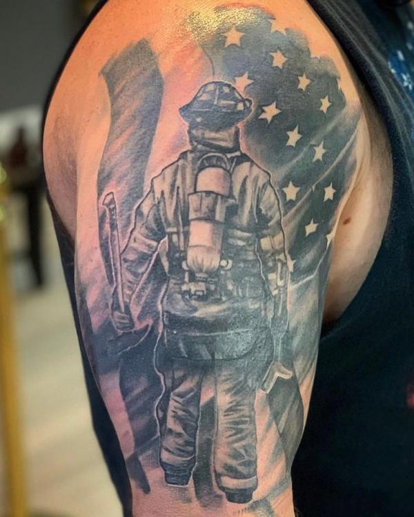 American fireman before flag half sleeve tattoo