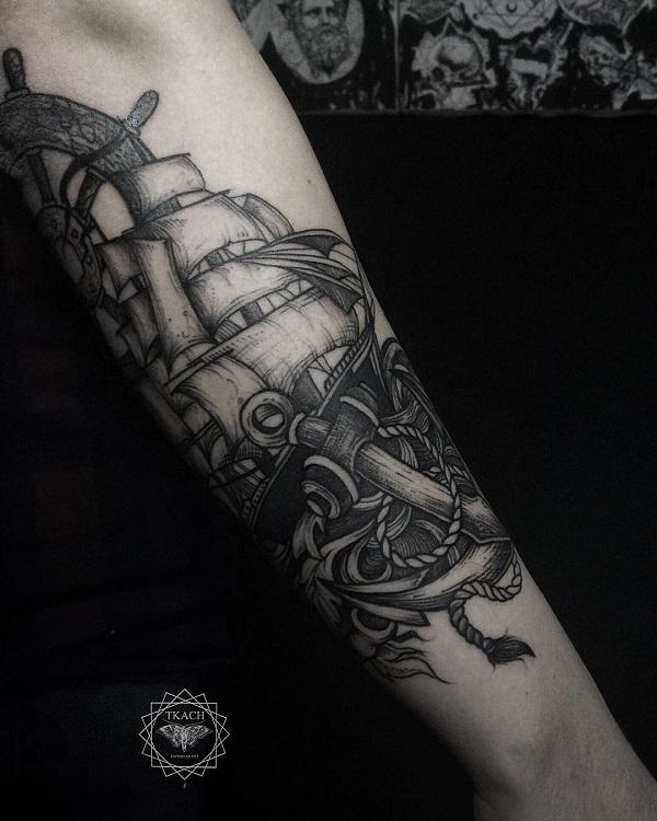 black and white boat tattoo with anchor on arm