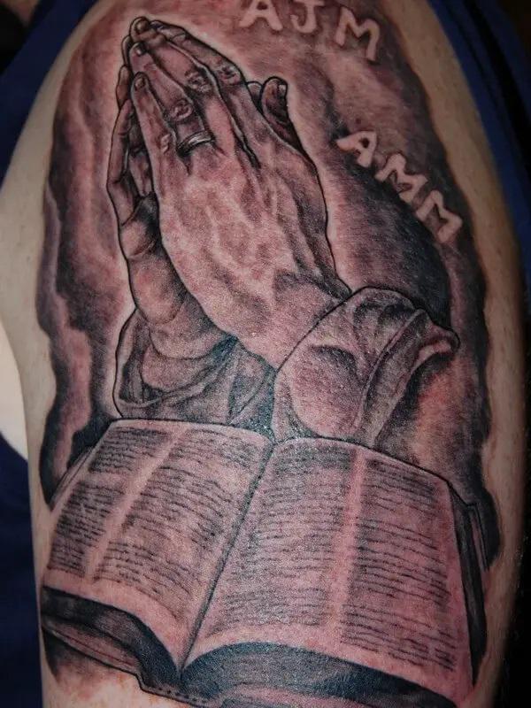 Praying Hands and bible tattoo