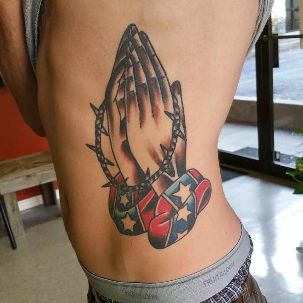 Praying hands with American flag tattoo