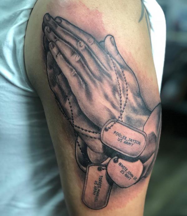Praying hands with dog tags
