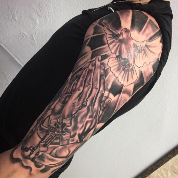Praying hands with dove tattoo