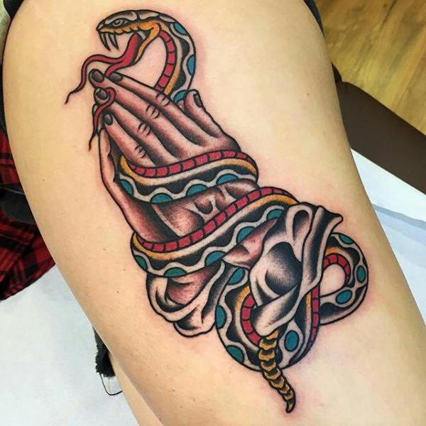 Praying hands with snake tattoo