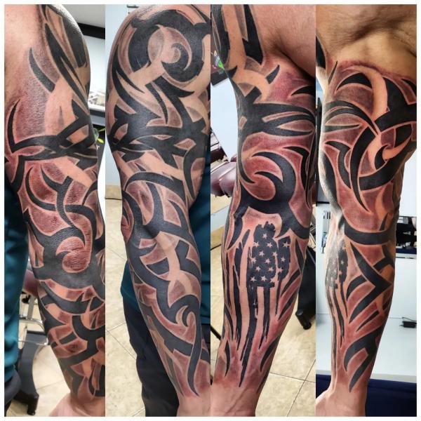 Tribal full sleeve tattoo with American flag element