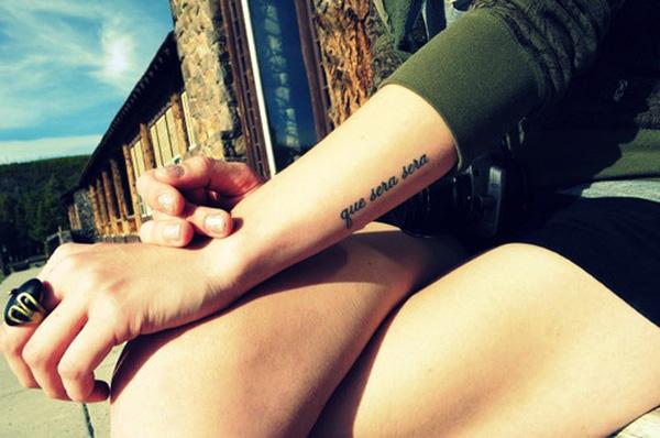 Small font tattoo Script lettering tattoo - Que Sera Sera on forearm