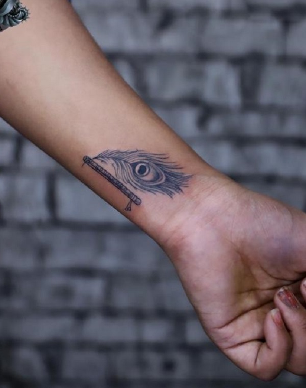 Cool Peacock feather wrist tattoo