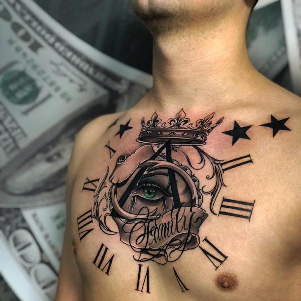 Eye in clock with stars and crown chest tattoo