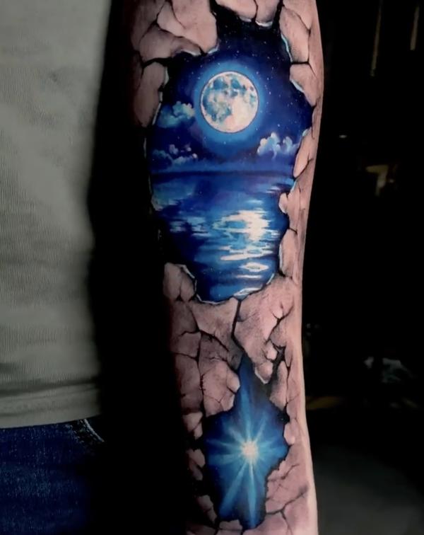 Ripped skin with moon tattoo