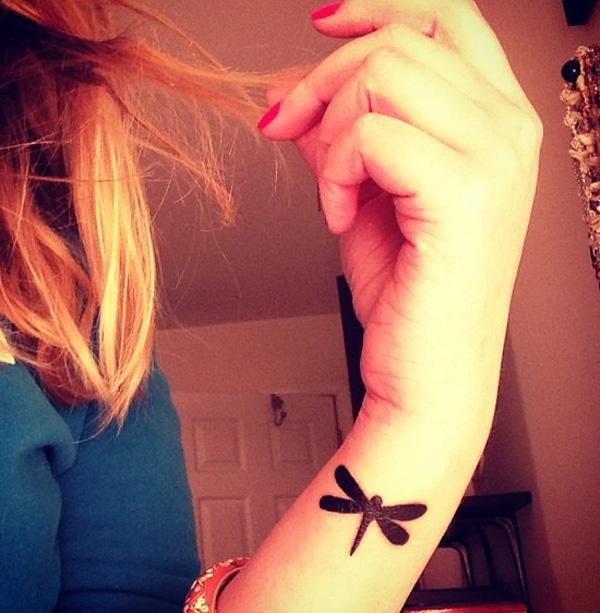 Dragonfly blackwork tattoo on wrist