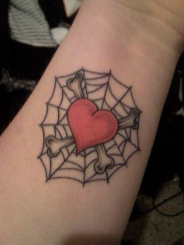 Red heart bonded in the web and cross tattoo