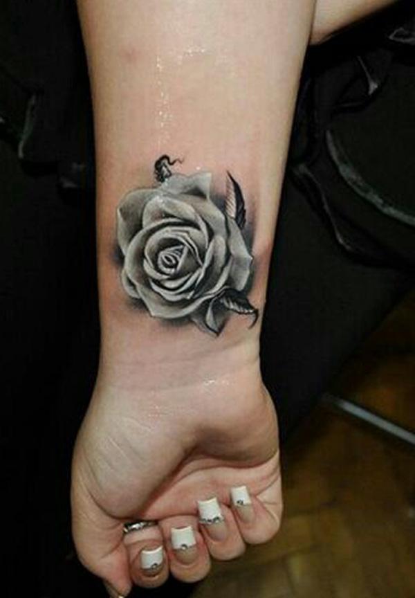 Grey rose tattoo on the wrist in realistic style
