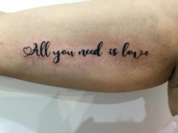 All you need is love bicep tattoo