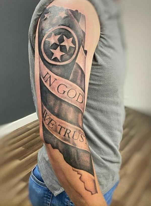 In god we trust arm tattoo 1