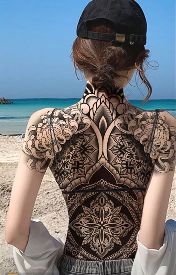 Backside of a Woman with Full Back Tattoos  Free Stock Photo