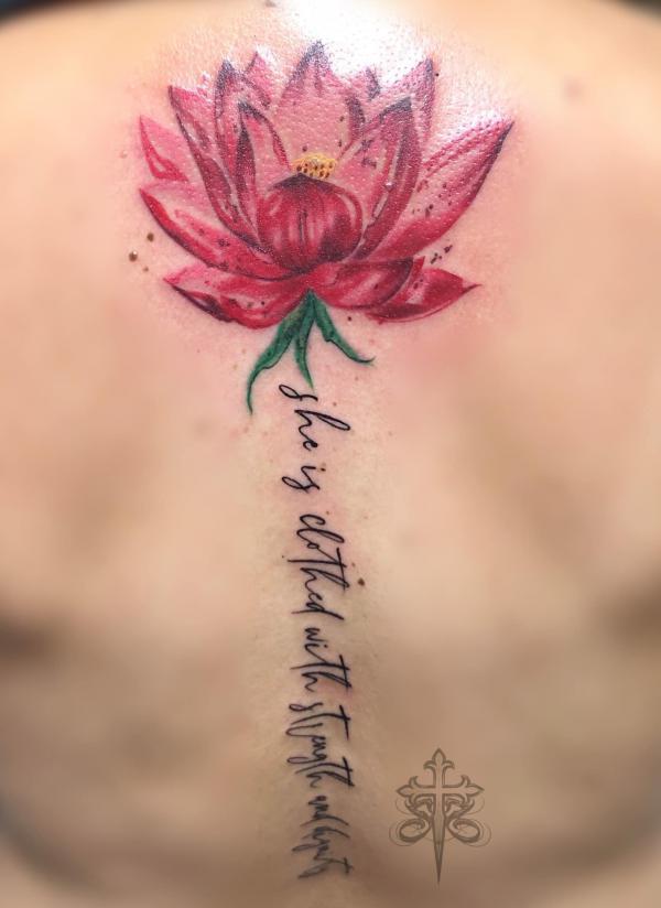 She is clothed in strength and dignity with lotus flower tattoo