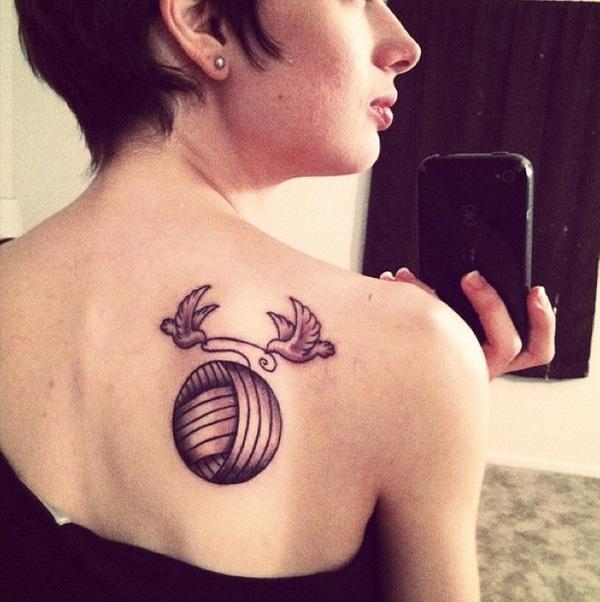 Two birds picking up yarn ball tattoo