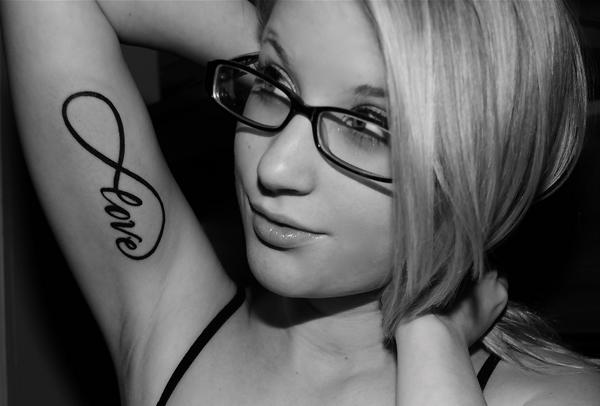 Infinite love symbol with love script bicep tattoo