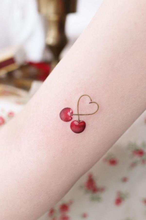 A pair of cherries forming a heart with their stems