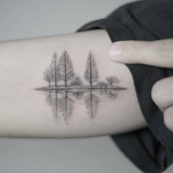 Little trees reflection in water small arm tattoo