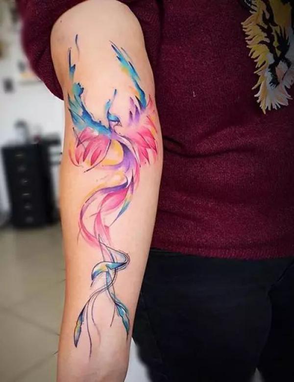 Rising phoenix watercolor tattoo on arm