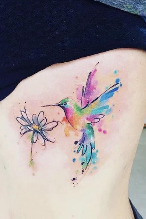 Simple watercolor hummingbird and daisy tattoo